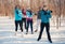 Group of friends stretching in the snow in winter