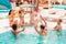 Group of friends in swimsuit enjoy in a swimming pool