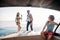 Group of friends take sunbath and swim in the water during a boat excursion