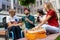 Group of friends taking a stroll on city`s street in summer day