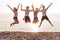 Group of friends together on the beach having fun. Happy young people jumping on the beach. Group of friends enjoying