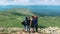 A group of friends, tourists resting on top of the mountain