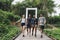 Group of friends walking on the bridge in a tropical countryside adventure and journey concept