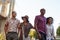 Group Of Friends Walking By Brooklyn Bridge In New York City