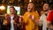 Group of Friends Watching a Live Soccer Match on TV in a Sports Bar. Three Men Cheering and Shouting