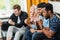 Group of friends watching television at home together