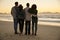 Group Of Friends On Winter Beach Watching Sunrise Together