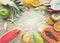 Group of fruits on sand background with shells.