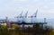 A group of full-revolving boom unloading and loading cranes in the port of Odessa.