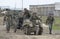 A group of German soldiers with the tractor SdKfz 2, and anti-tank guns moving on the road. Reconstruction of the episode of the