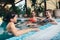 Group of girlfriends having fun in the indoor swimming pool in spa center