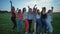 A group of girls are dancing outdoors in the evening.