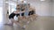 Group of girls does stretching exercise in dancing school