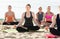 Group girls making yoga meditation in lotus pose