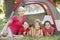 Group Of Girls With Mother Having Fun In Tent In Countryside