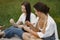 Group of girls play cards in a park