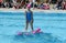 Group of girls in a pool practicing synchronized swimming