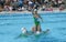 Group of girls in a pool practicing synchronized swimming