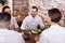 Group of glad friends eating at restaurant and chatting