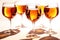 Group of glasses with amber wine, radiating a rich, deep orange hue on a white table. Scene emanates a luxurious yet minimalist