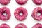 Group of glazed pink donuts on a blue background