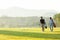 Group golf professional Golfer asian man walking in fairway with bag golf at golf  club.
