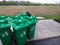 Group of green bins for general waste in plaza