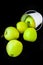 A group of green Granny Smith and golden apples in a white bucket against a dark brown background, copy space for text