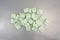 Group of green packing peanuts on a metal surface