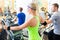 Group in gym on elliptical trainer