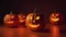 A group of Halloween pumkins jack o\\\' lantern on the floor and glowing light, Happy Halloween decorations in the house.