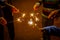 Group hands holding Burning sparking stick starlight fireworks pyrotechnic warm