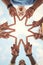 Group hands, star finger and support, freedom and motivation on blue sky background. Closeup teamwork friends below