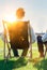 Group of handsome businessmen relaxing and talking about life while sitting on folding chair at park