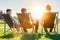 Group of handsome businessmen relaxing and talking about life while sitting on folding chair at park