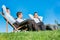 Group of handsome businessmen relaxing and talking about life while sitting on folding chair at park