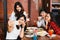 Group of Happy Asian male and female friends taking a selfie photo and having a social toast together in restaurant.