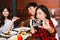 Group of Happy Asian male and female friends taking a selfie photo and having a social toast together in restaurant.