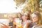 Group of happy and cheerful young women friends enjoy and celebrate social life together - people toasting and clinking outdoor