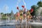 Group of happy Cheerleaders enjoy jogging through the fountain