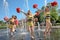 Group of happy Cheerleaders enjoy jogging through the fountain