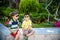 Group of happy children playing outdoors. Kids having fun in park during summer vacation. Friends sitting in sunglasses and