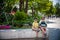 Group of happy children playing outdoors. Kids having fun in park during summer vacation. Friends sitting in sunglasses and