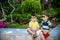 Group of happy children playing outdoors. Kids having fun in park during summer vacation. Friends sitting in sunglasses and