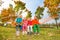 Group of happy children sitting on hammock in park