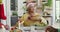 Group of happy diverse senior friends in santa hats passing food at christmas dinner table at home