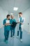 Group of happy doctors walk along the hospital corridor