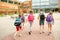 Group of happy elementary school students running