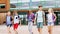 Group of happy elementary school students walking