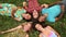 Group of happy friends forming a circle with their heads laying back on grass